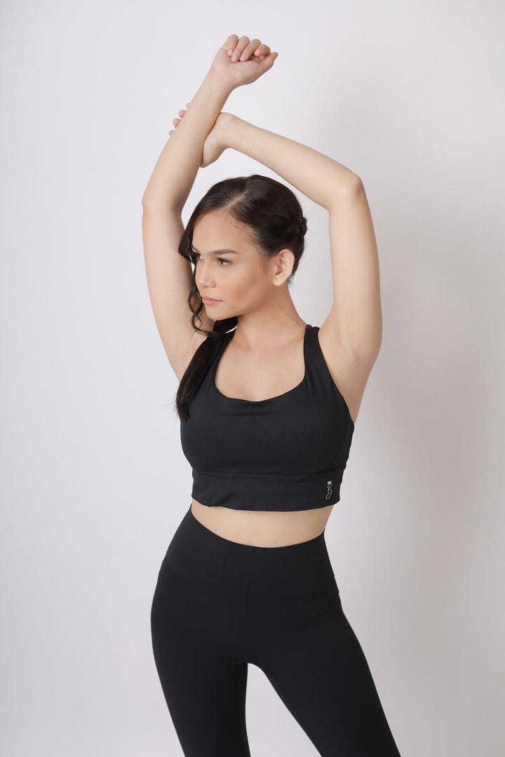 A lady wearing Beauty Lyfe Activewear Hana Model Black sports bra and in leggings