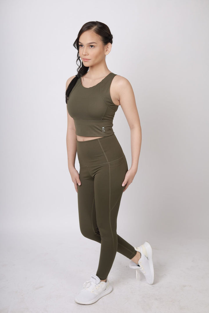 A lady wearing Beauty Lyfe Activewear Elisse Model Olive Green Leggings and in sports bra