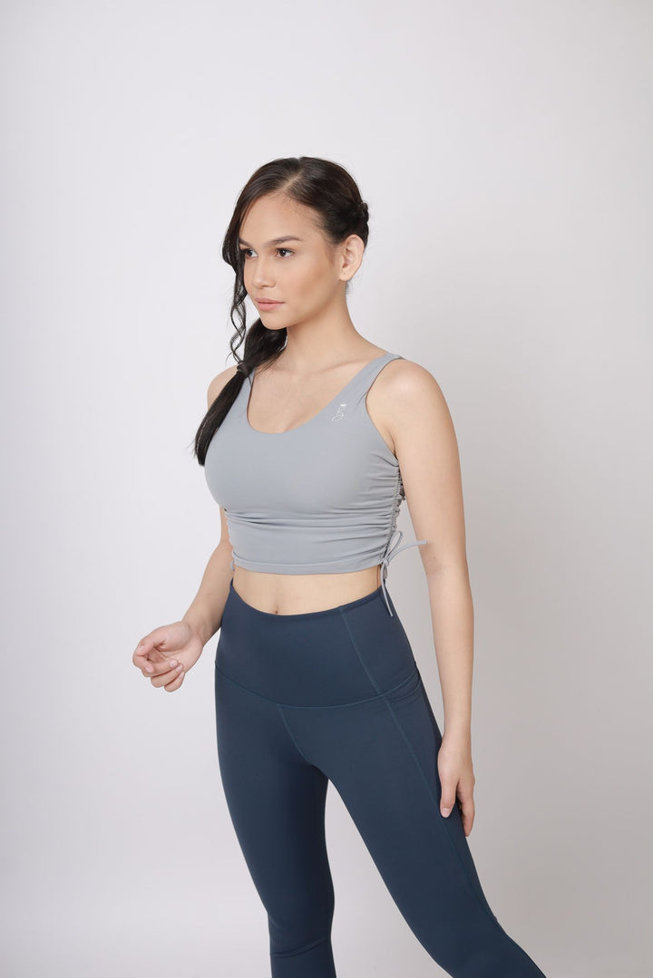 A lady wearing Beauty Lyfe Activewear Gracie Model Gray sports bra and in leggings