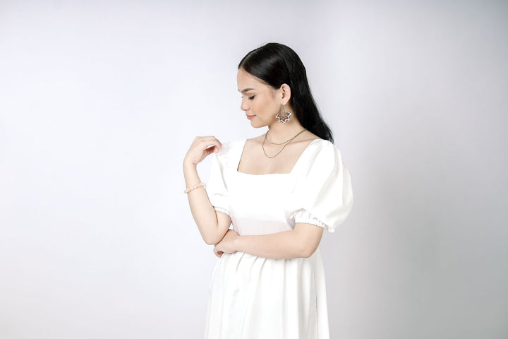A lady wearing Beauty Lyfe Dress Abora Backless Puff Dress in White Model