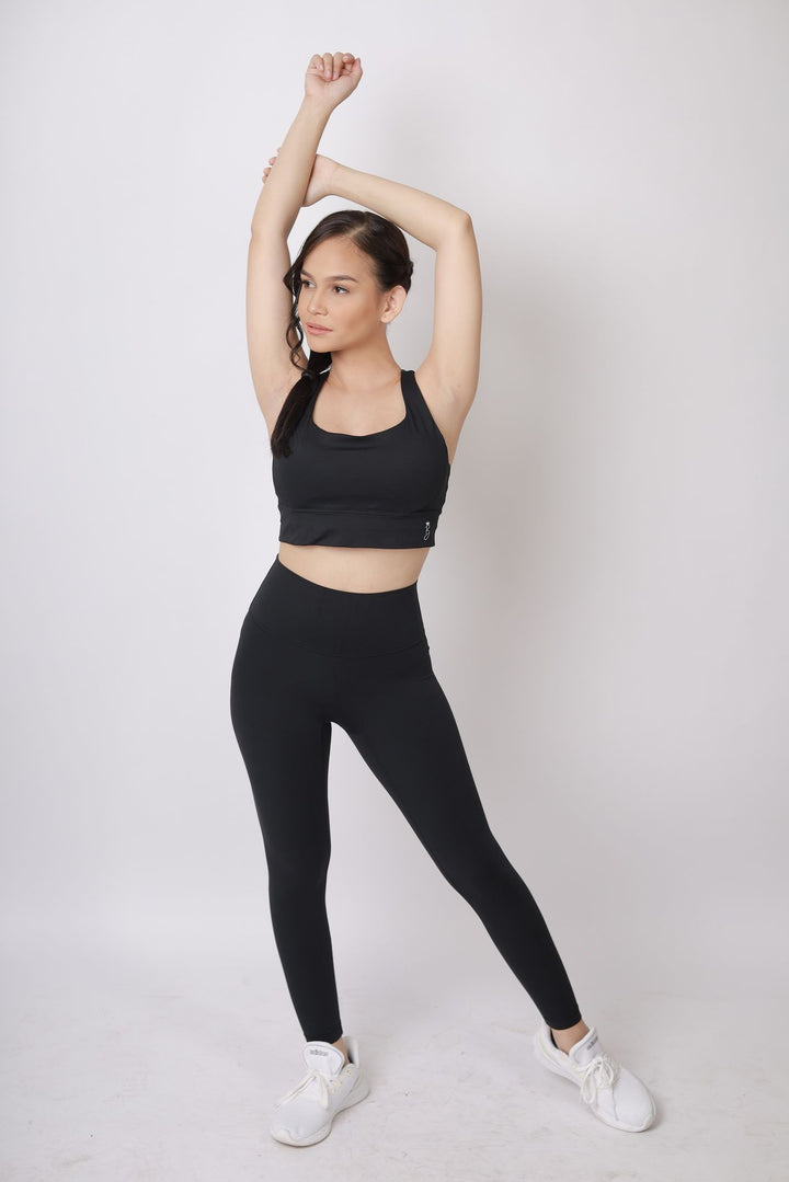 A lady wearing Beauty Lyfe Activewear Hana Model Black sports bra and in leggings