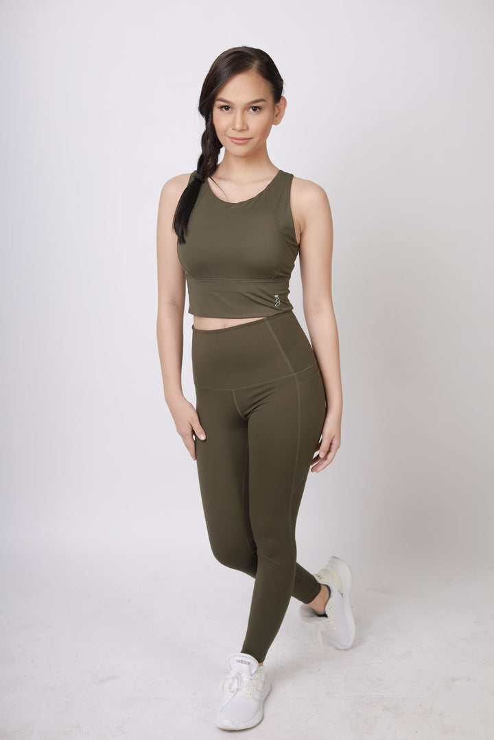 A lady wearing Beauty Lyfe Activewear Elisse Model Olive Green Leggings and in sports bra