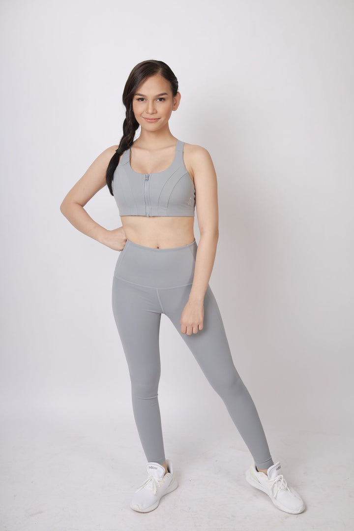 A lady wearing Beauty Lyfe Activewear Gracie Model Gray sports bra and in leggings