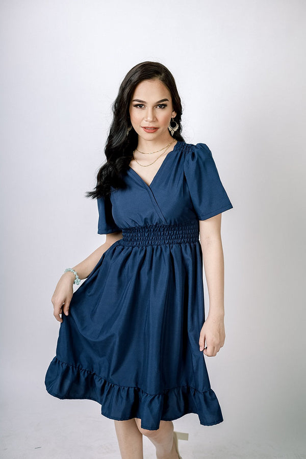A lady wearing Beauty Lyfe Dress Danny V-Neck Dress Navy Blue Model