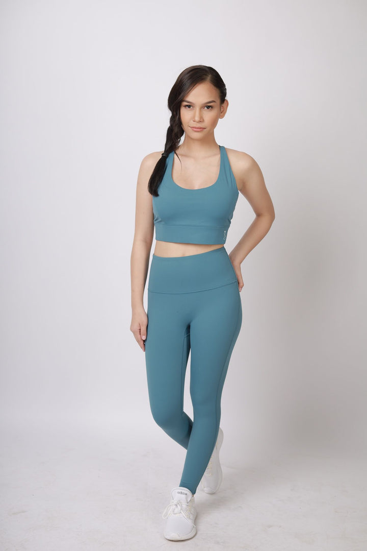 A lady wearing Beauty Lyfe Activewear Samantha Model Lake Blue sports bra and in leggings