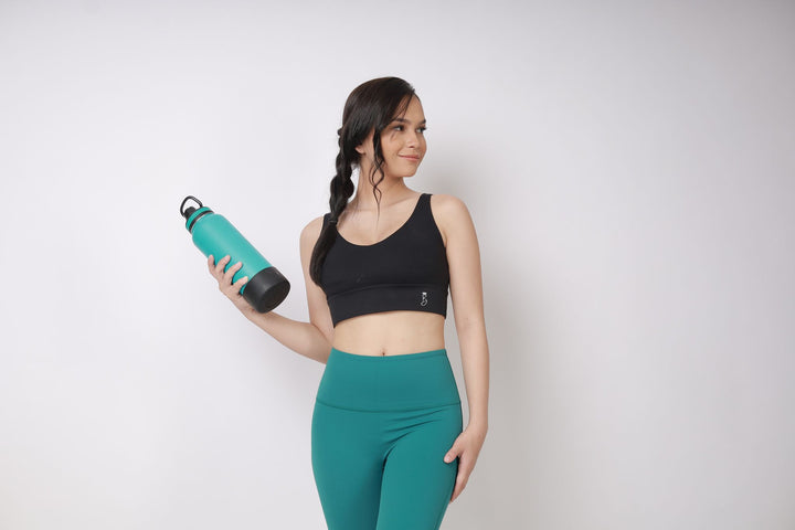 A lady wearing Beauty Lyfe Activewear Aina Model Lake Green leggings and in sports bra