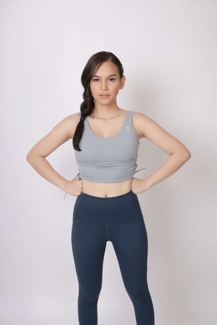 A lady wearing Beauty Lyfe Activewear Gracie Model Gray sports bra and in leggings