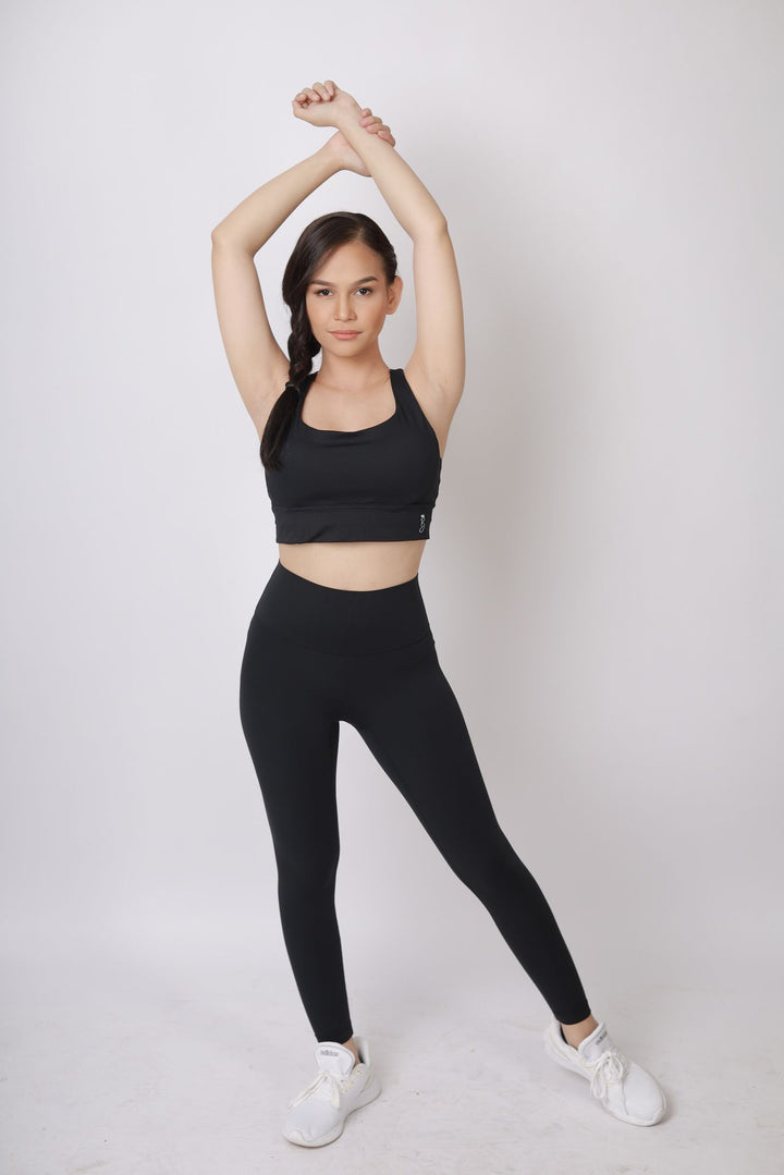 A lady wearing Beauty Lyfe Activewear Hana Model Black sports bra and in leggings