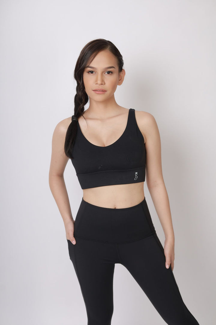 A lady wearing Beauty Lyfe Activewear Hana Model Black sports bra and in leggings