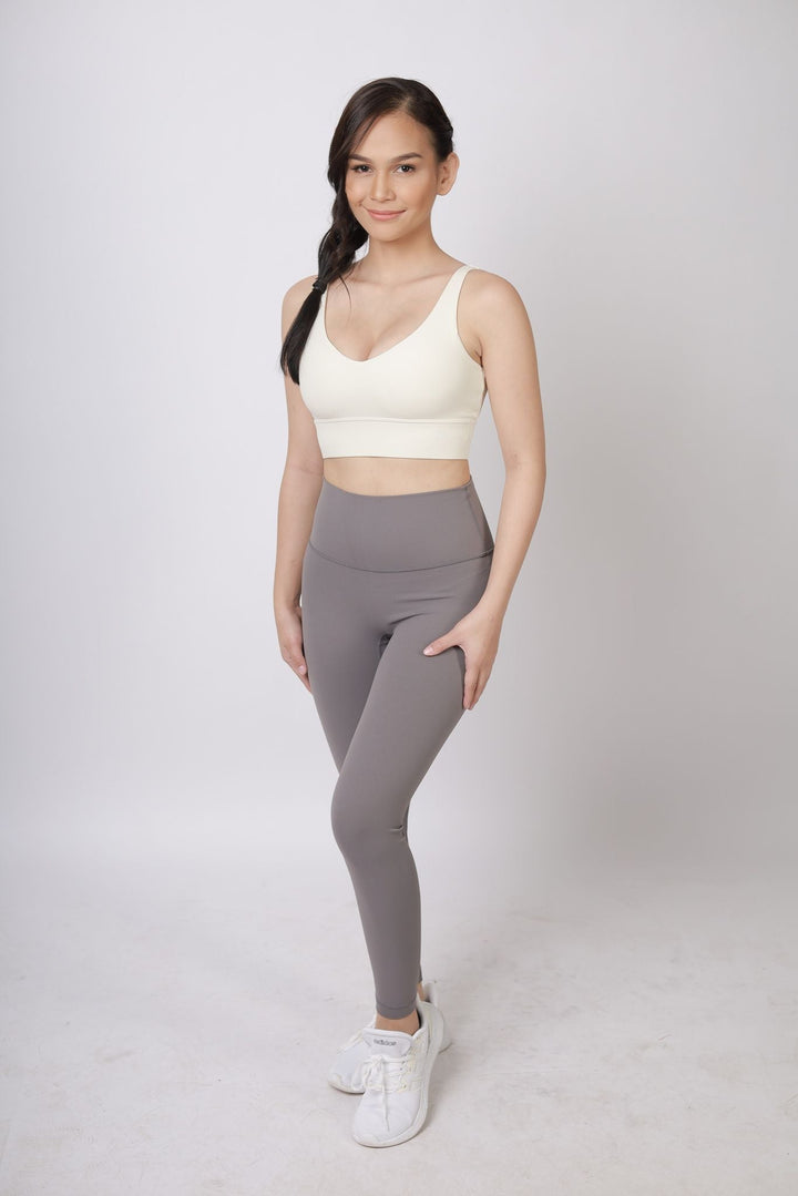 A lady wearing Beauty Lyfe Activewear Scarlett Model Dark Gray Leggings and in sports bra