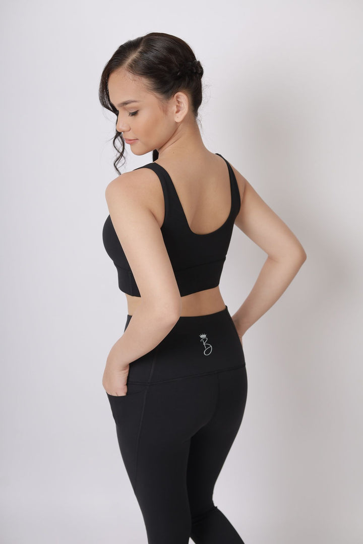 A lady wearing Beauty Lyfe Activewear Hana Model Black sports bra and in leggings