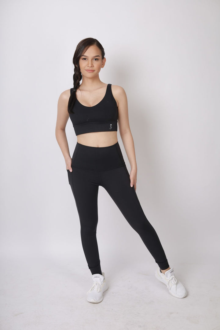 A lady wearing Beauty Lyfe Activewear Hana Model Black sports bra and in leggings