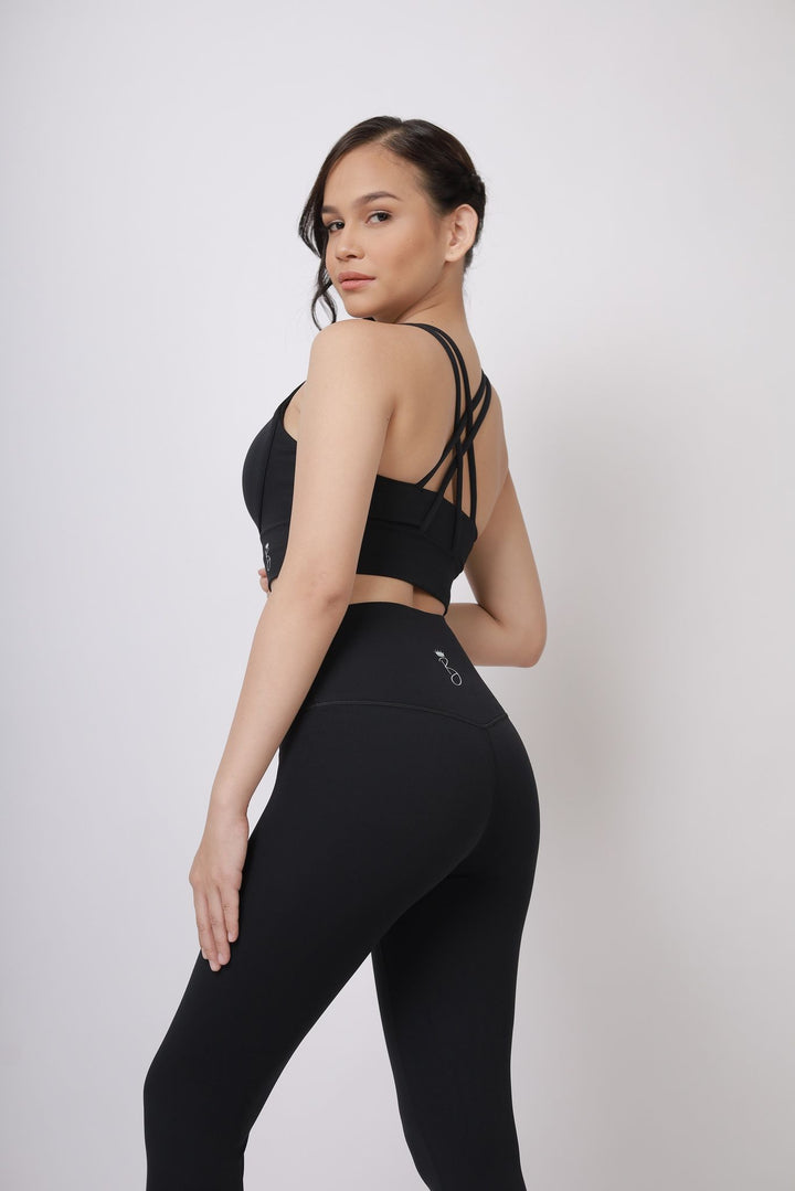 A lady wearing Beauty Lyfe Activewear Hana Model Black sports bra and in leggings