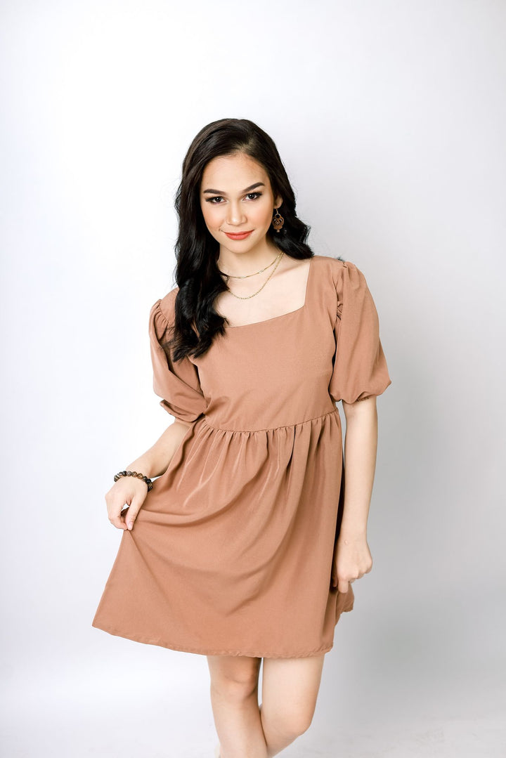 A lady wearing Beauty Lyfe Dress Abora Backless Puff Dress in Brown Model