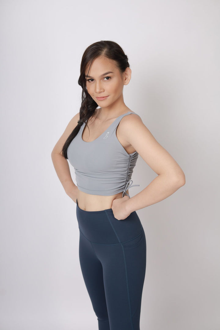 A lady wearing Beauty Lyfe Activewear Gracie Model Gray sports bra and in leggings