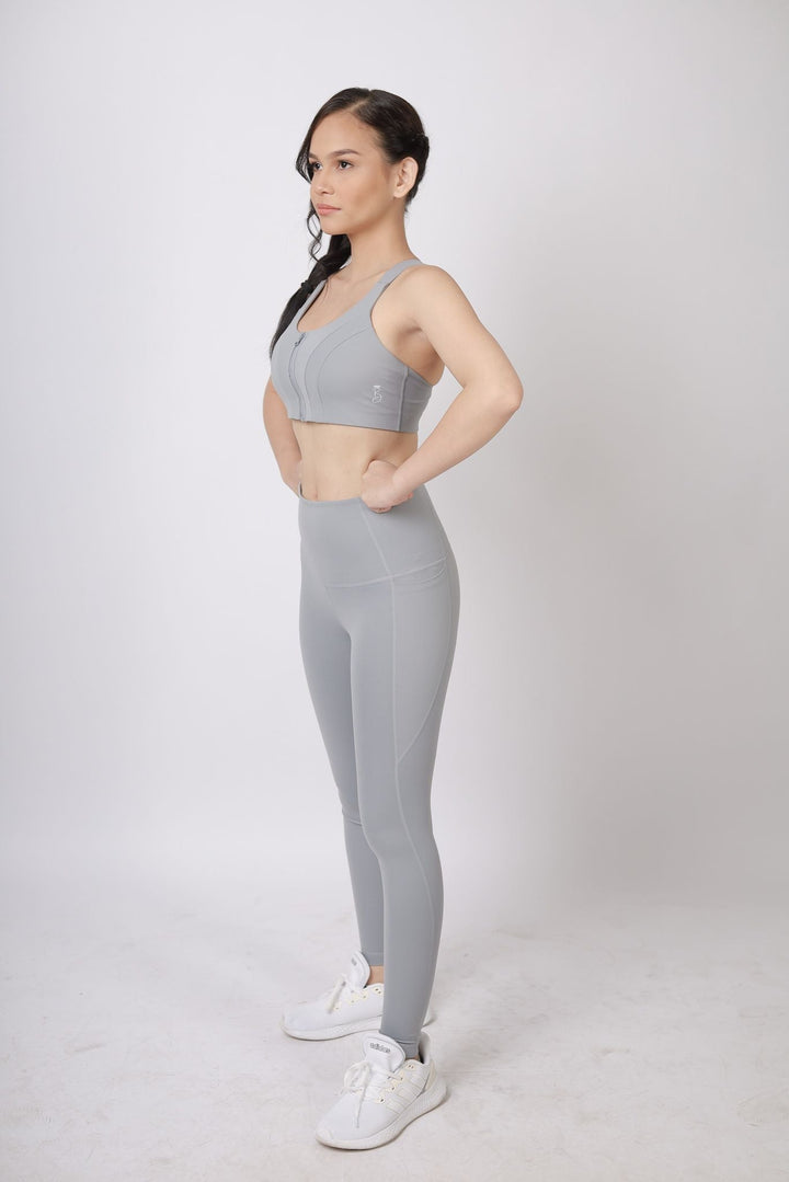 A lady wearing Beauty Lyfe Activewear Gracie Model Gray Leggings and in sports bra