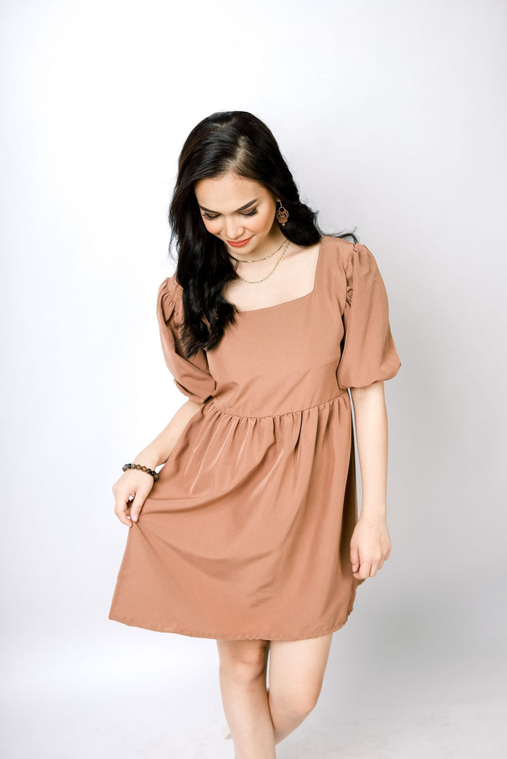 A lady wearing Beauty Lyfe Dress Abora Backless Puff Dress in Brown Model