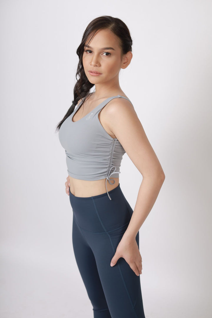 A lady wearing Beauty Lyfe Activewear Gracie Model Gray sports bra and in leggings