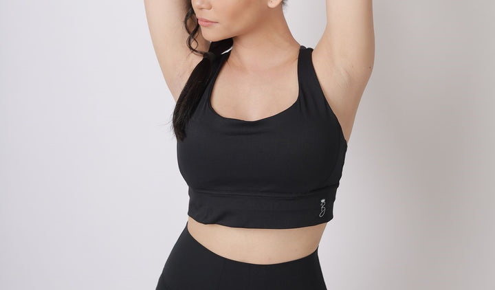 A lady wearing Beauty Lyfe Activewear Hana Model Black sports bra and in leggings