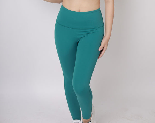 A lady wearing Beauty Lyfe Activewear Aina Model Lake Green leggings and in sports bra