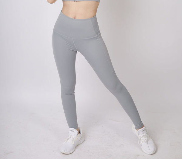 A lady wearing Beauty Lyfe Activewear Gracie Model Gray Leggings and in sports bra